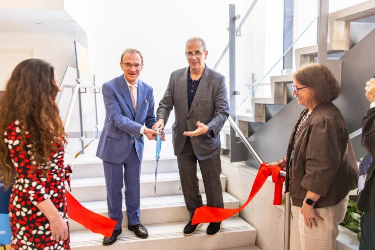 Michael Jordan (left), associate vice president of University Health Services, and Mike Howard, executive vice president of Tufts University, cut a ceremonial ribbon during the grand opening of the Boston Student and Occupational Health Clinic on June 4. Photo by Andy Kwok