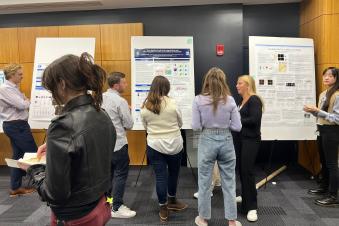 Students and faculty looking at research posters at the 2023 Charlton Poster Competition