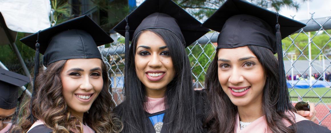 Three MPH alumni in their graduation robes