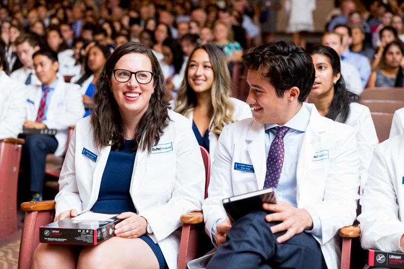 Students sit at white coat ceremony at Tufts