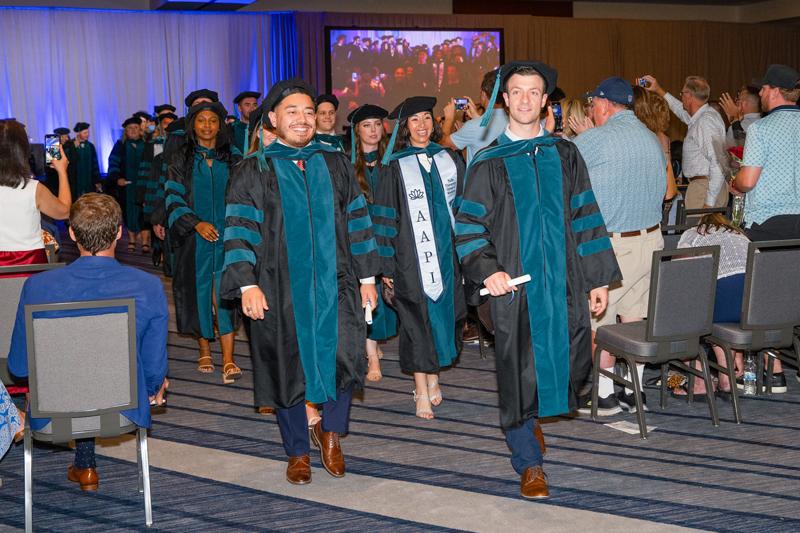 DPT students walk out of hooding graduation ceremony in Phoenix, AZ.