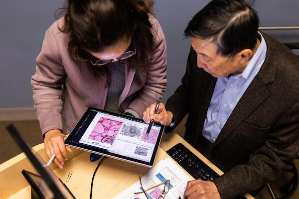 Professor explains content to MBS student during class