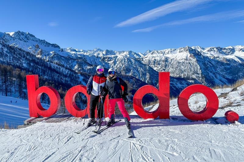 Galley and Thorr pose on top of a mountain while in ski gear