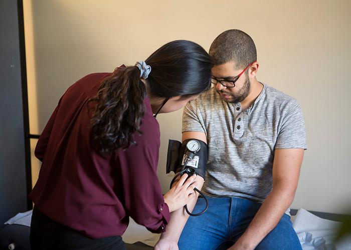 Malden, Mass. Patient Mohammed Lazaar is treated by Amanda Yuan during a Sharewood Project Clinic in Malden (Tim Correira for Tufts University)