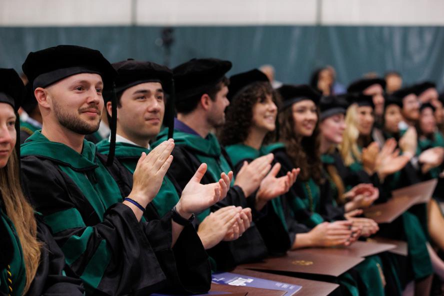 M25 students clapping at Commencement