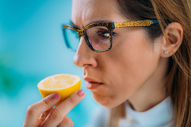 Woman sniffing lemon