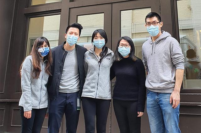 Five people pose outside the Greater Boston Chinese Golden Age Center in Chinatown.