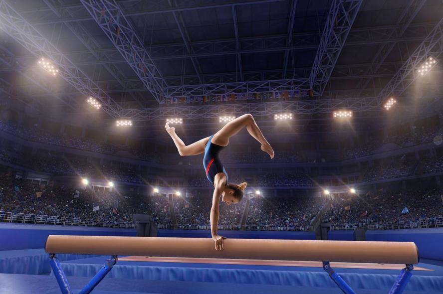 A female gymnast performs a routine on the balance beam