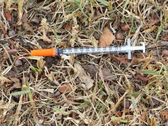 Picture of a syringe on the ground