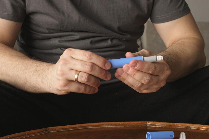 A man holds an injectable weight-loss drug
