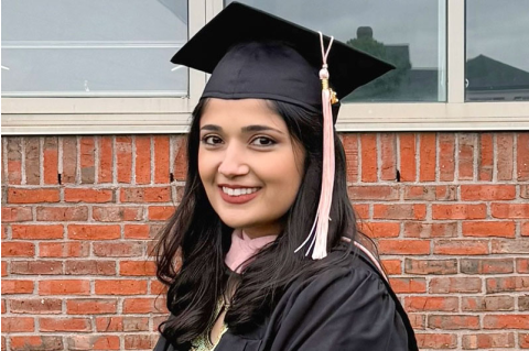 Headshot image of Zara in her graduation cap and gown