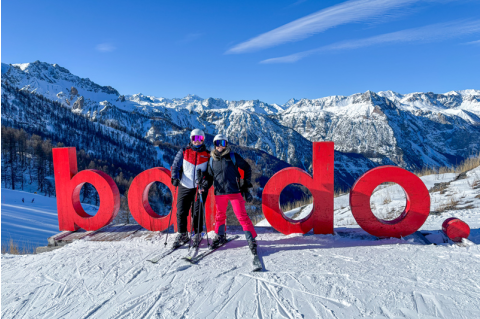 Galley and Thorr pose on top of a mountain while in ski gear