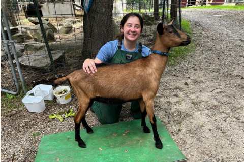 Eleanor Kharasch outside posing with a goat