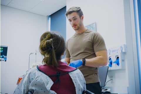 Noah Leaf speaks with patient in clinical setting