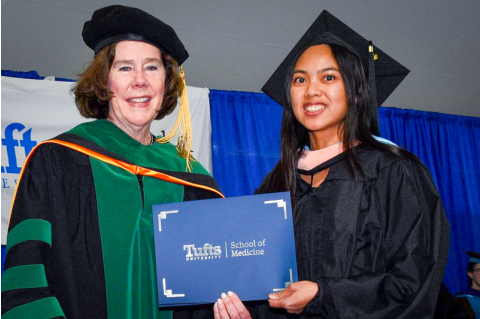 Barit receiving her degree at Commencement, posing with Dean Boucher.