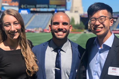 Sharewood staff at Gillette Stadium for the award ceremony: Kelly Ohlrich, MBS18, M22; Matthew Gooden, MBS20; and Andy Wang, M22.