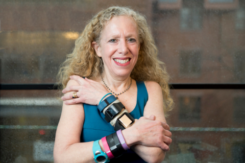 Lisa Gualtieri with many used fitness trackers