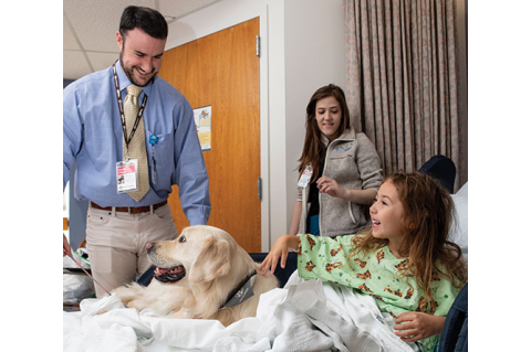 Connor O’Boyle, MG17 (MBS), M21, and Dublin, his golden retriever at the Floating Hospital for Children