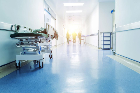 An empty hospital hallway with a stretcher