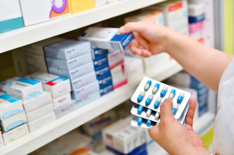A pharmacist handles prescription medications