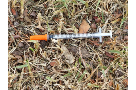 Picture of a syringe on the ground