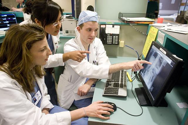 Doctors and students reviewing images on a computer screen